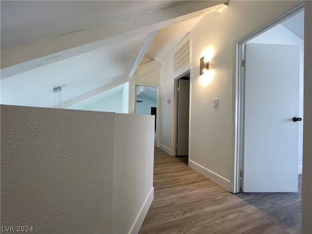 hallway featuring hardwood / wood-style flooring and lofted ceiling with beams