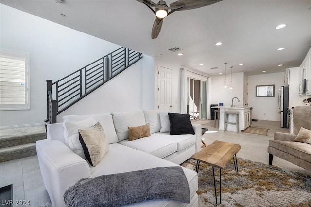 living room featuring sink and ceiling fan