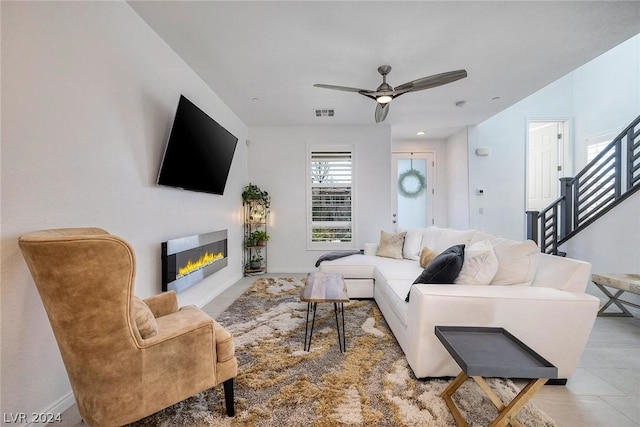 tiled living room featuring ceiling fan