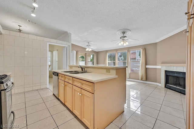 kitchen featuring light tile patterned flooring, a center island with sink, stainless steel appliances, and sink