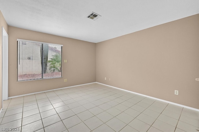 empty room featuring light tile patterned floors