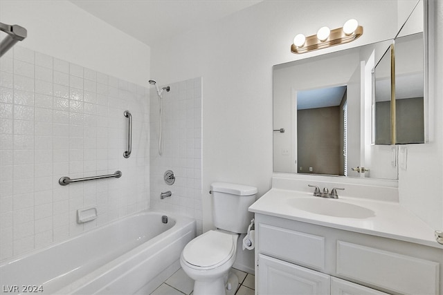 full bathroom featuring toilet, vanity, tile patterned floors, and tiled shower / bath