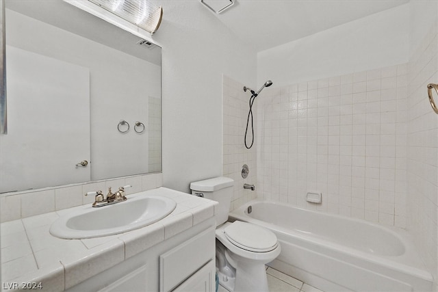 full bathroom with vanity, tile patterned floors, tiled shower / bath combo, and toilet