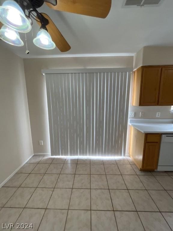 kitchen featuring ceiling fan, white dishwasher, and light tile patterned floors