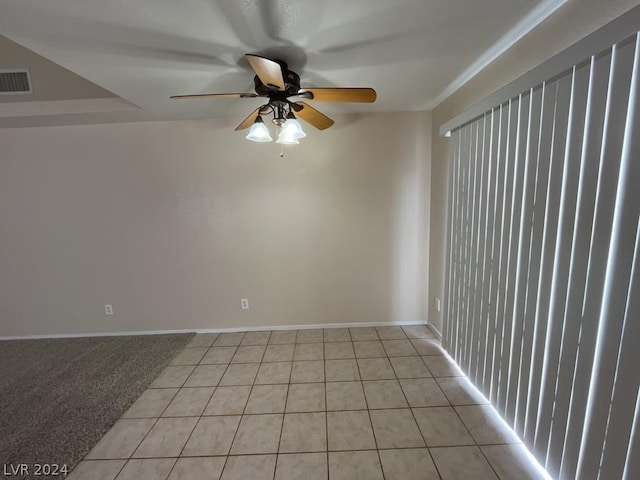 carpeted spare room with ceiling fan