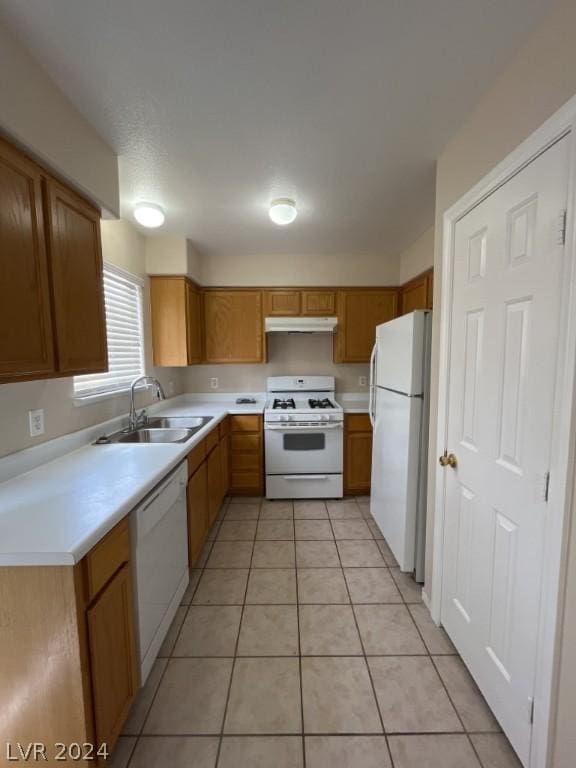 kitchen with sink, white appliances, and light tile patterned floors