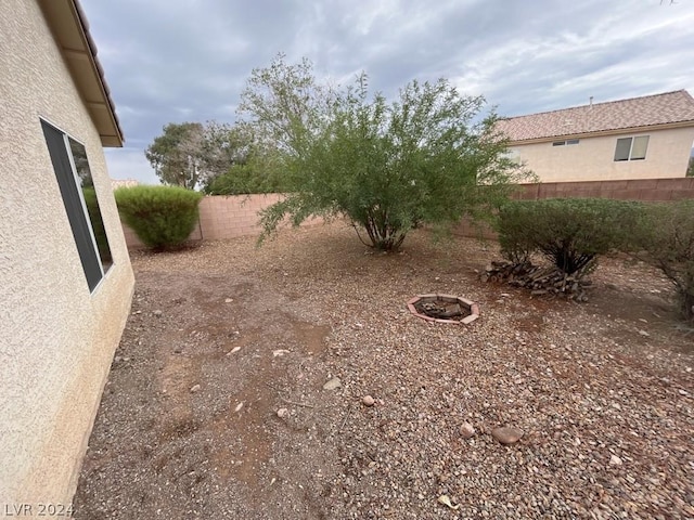 view of yard with a fire pit