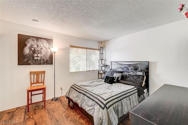 4770 Topaz St Unit 18, Las Vegas, NV 89121 - bedroom featuring wood finished floors, baseboards, and a textured ceiling