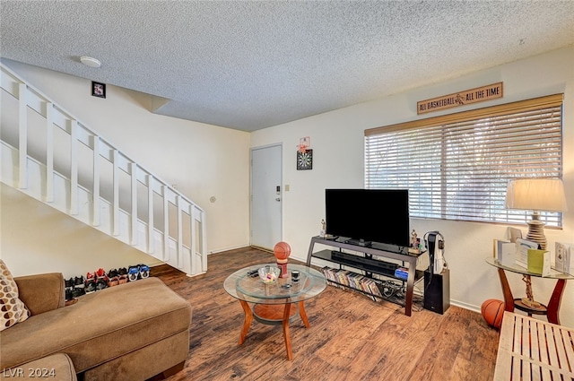 living room with a textured ceiling and hardwood / wood-style floors