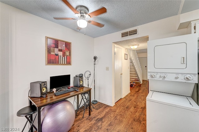 interior space with stacked washer / dryer, a textured ceiling, hardwood / wood-style floors, and ceiling fan