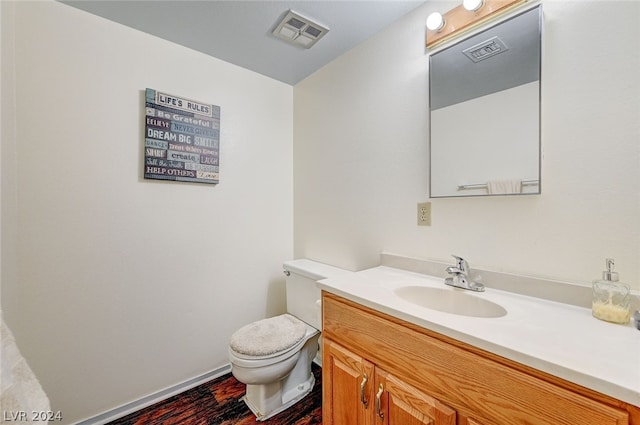 bathroom featuring hardwood / wood-style floors, toilet, and vanity