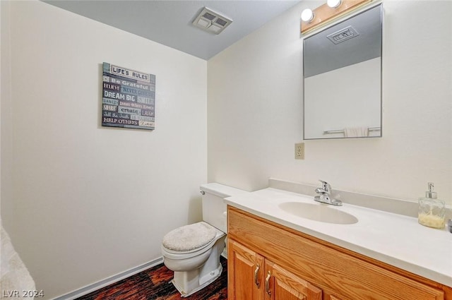 4770 Topaz St Unit 18, Las Vegas, NV 89121 - half bathroom featuring visible vents, toilet, wood finished floors, and vanity