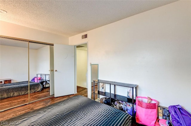 4770 Topaz St Unit 18, Las Vegas, NV 89121 - bedroom with visible vents, a textured ceiling, a closet, and wood finished floors