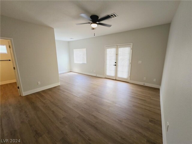 unfurnished room featuring dark wood-type flooring, ceiling fan, and french doors