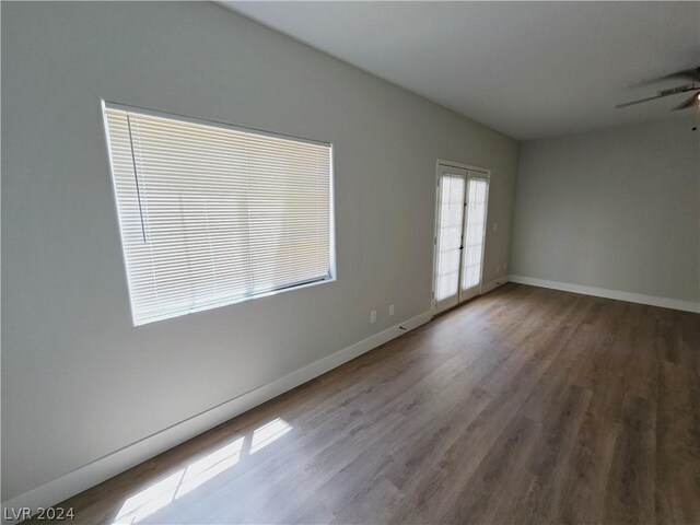 spare room with hardwood / wood-style floors and ceiling fan