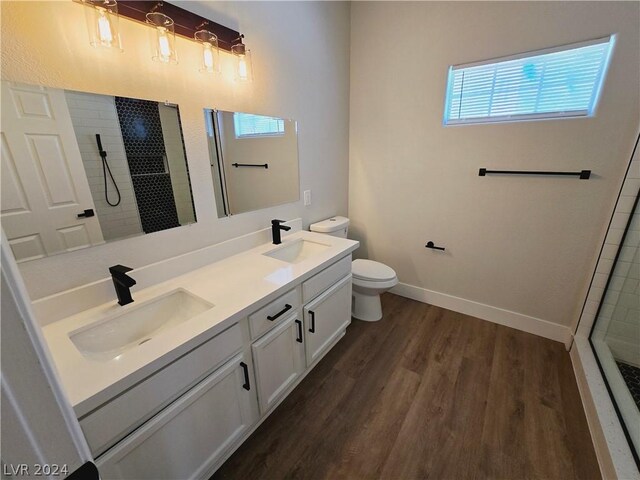 bathroom featuring a healthy amount of sunlight, toilet, wood-type flooring, and a shower