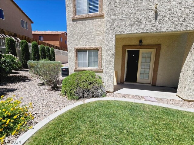 doorway to property featuring a yard