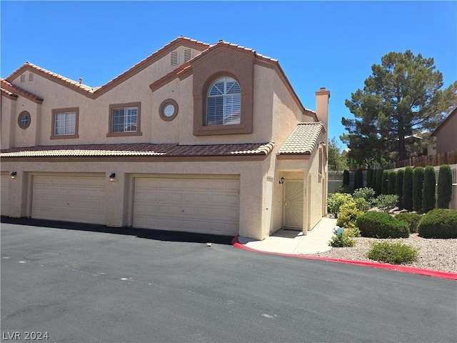 mediterranean / spanish house with a garage