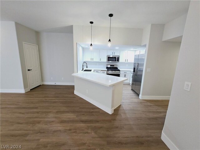 kitchen featuring sink, hanging light fixtures, stainless steel appliances, dark hardwood / wood-style floors, and white cabinets