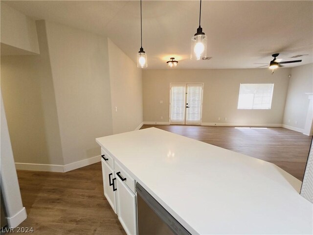 kitchen with hanging light fixtures, white cabinetry, dark hardwood / wood-style floors, and ceiling fan