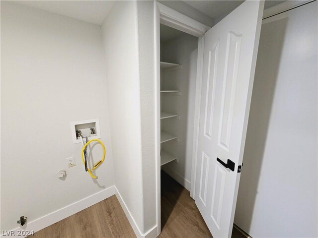 laundry room with hookup for a gas dryer, hardwood / wood-style flooring, and washer hookup