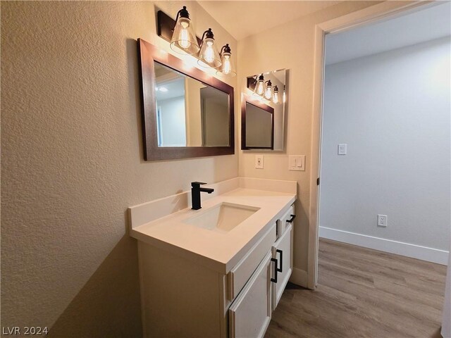 bathroom featuring hardwood / wood-style flooring and vanity