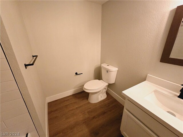 bathroom featuring vanity, hardwood / wood-style floors, and toilet