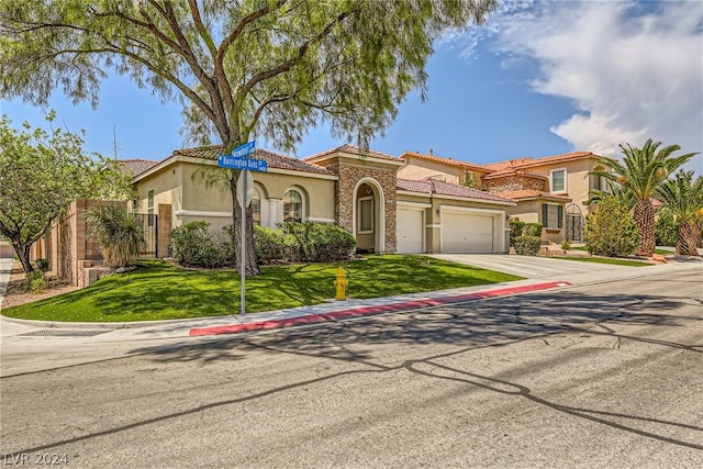 mediterranean / spanish-style house with a front lawn