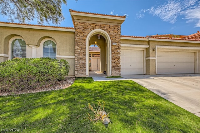1505 Barrington Oaks St, North Las Vegas, NV 89084 - mediterranean / spanish house featuring stucco siding, driveway, a tile roof, and a garage