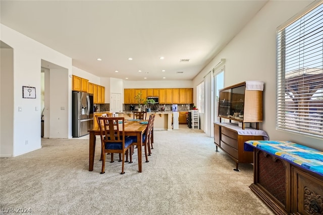 dining room with light colored carpet