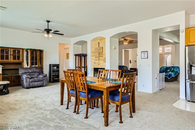 dining area with light carpet and ceiling fan