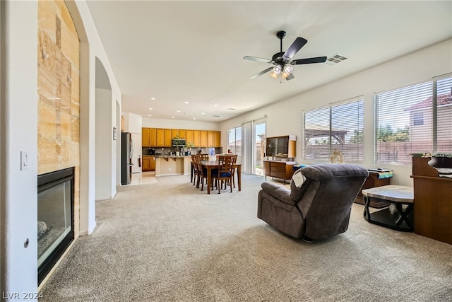 living room with light carpet and ceiling fan