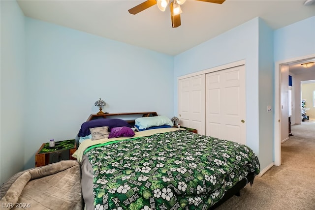 carpeted bedroom with ceiling fan and a closet