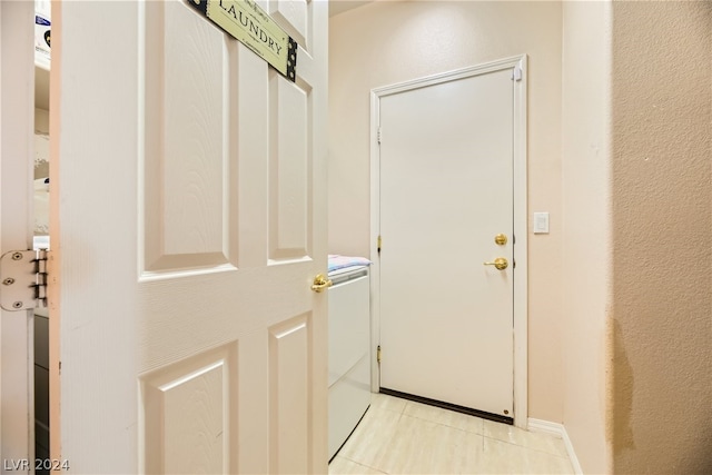 doorway featuring light tile patterned flooring