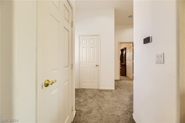 hall featuring light colored carpet