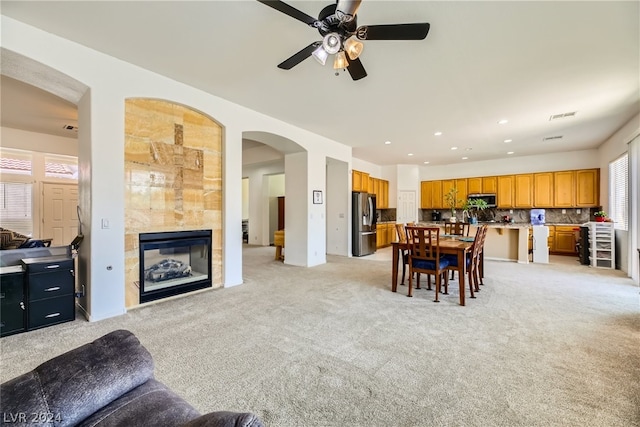 1505 Barrington Oaks St, North Las Vegas, NV 89084 - dining room with light colored carpet, a fireplace, a ceiling fan, arched walkways, and recessed lighting