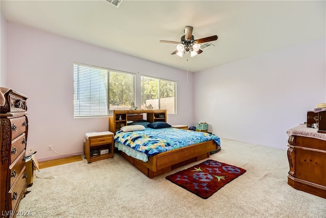 bedroom featuring light colored carpet and ceiling fan