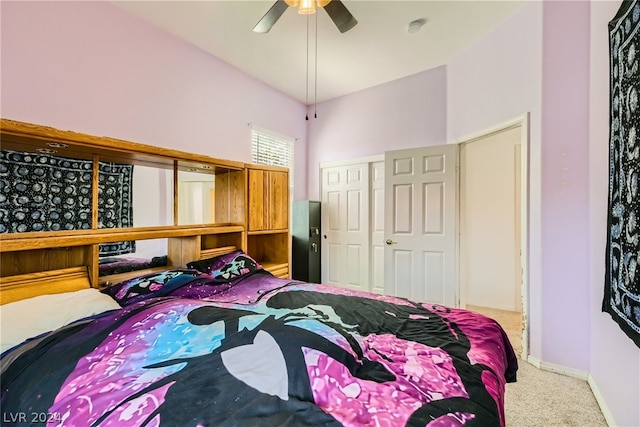 carpeted bedroom featuring ceiling fan and a closet