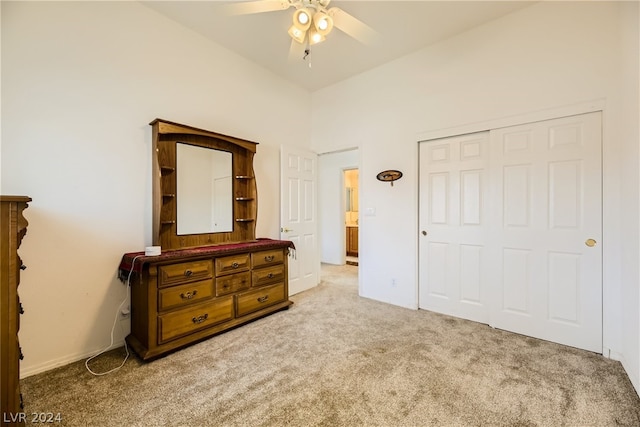 bedroom with a closet, light colored carpet, and ceiling fan