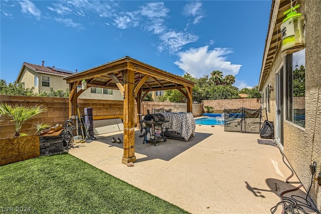 view of patio / terrace featuring a fenced in pool and a gazebo