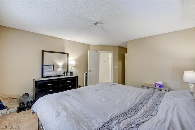 bedroom with carpet flooring and a textured ceiling