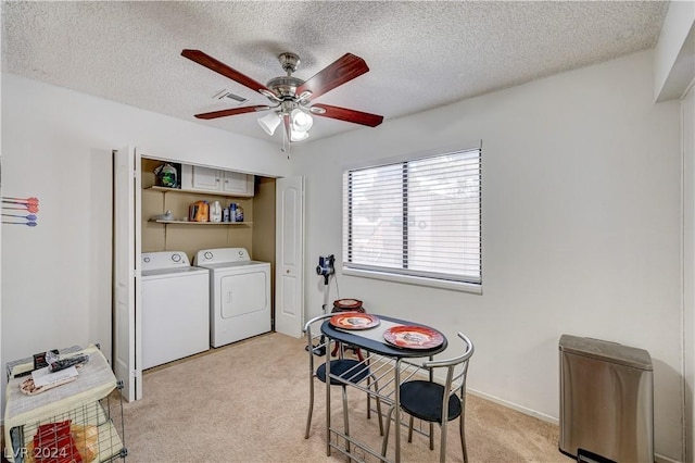 laundry area featuring ceiling fan, light colored carpet, a textured ceiling, and independent washer and dryer