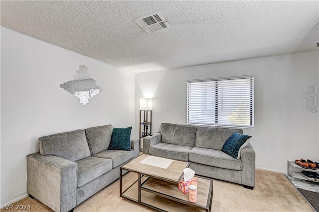 carpeted living room with a textured ceiling