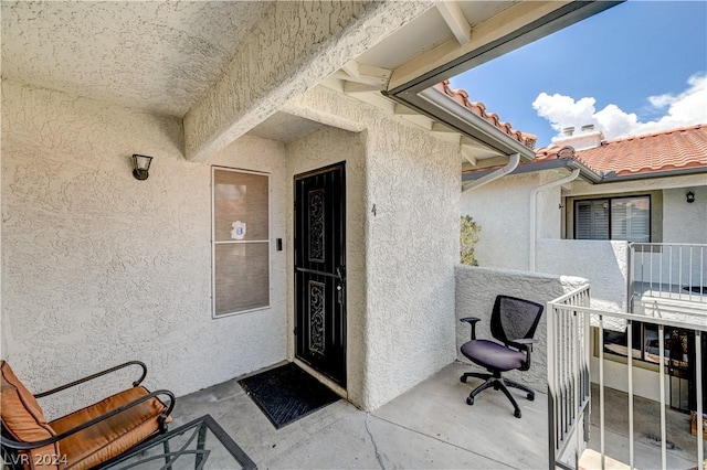 doorway to property featuring a balcony