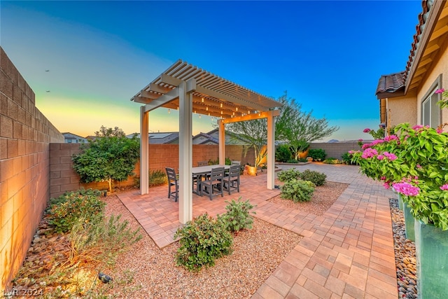 patio terrace at dusk with a pergola