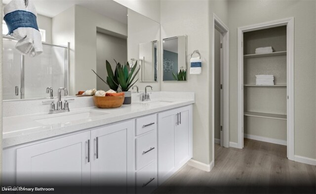 bathroom featuring hardwood / wood-style floors and dual vanity