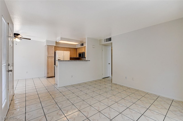 unfurnished living room with light tile patterned floors and ceiling fan