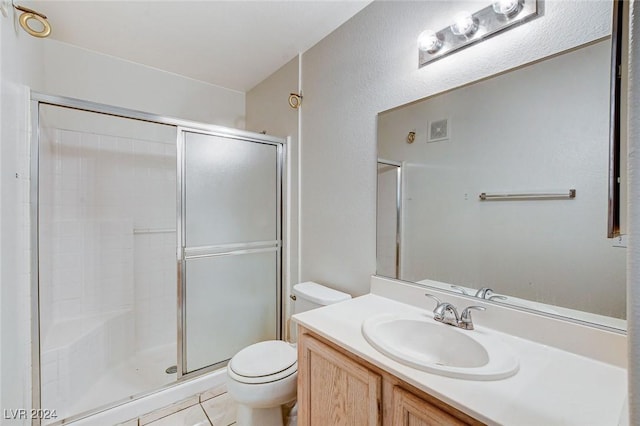 bathroom featuring a shower with door, vanity, and toilet