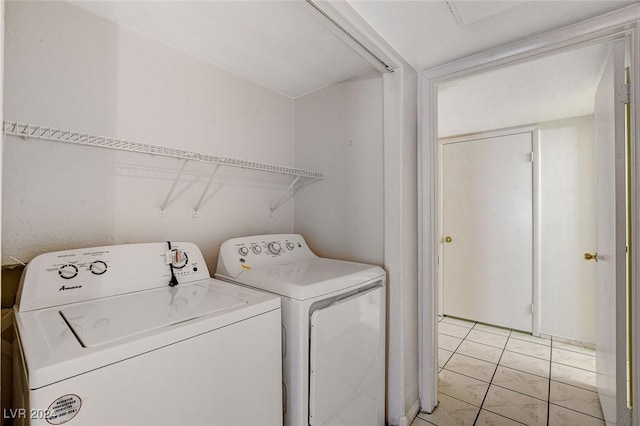 washroom with light tile patterned floors and washer and clothes dryer