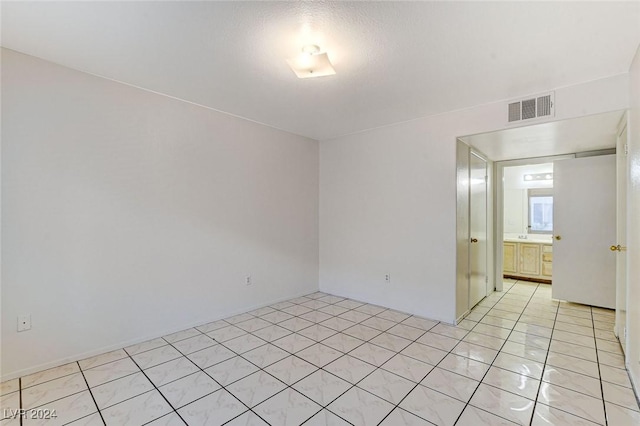 spare room featuring light tile patterned floors